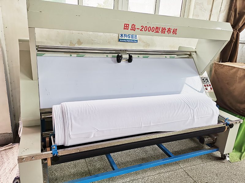 Fabric inspection machine checking incoming material